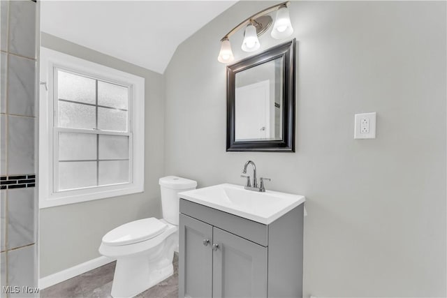 563 E 260th St, Euclid, OH 44132 - bathroom featuring lofted ceiling, vanity, toilet, and baseboards