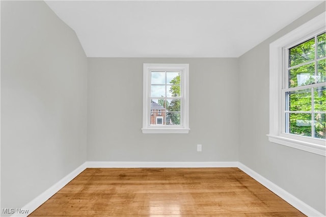 563 E 260th St, Euclid, OH 44132 - empty room featuring light wood-type flooring, baseboards, and lofted ceiling