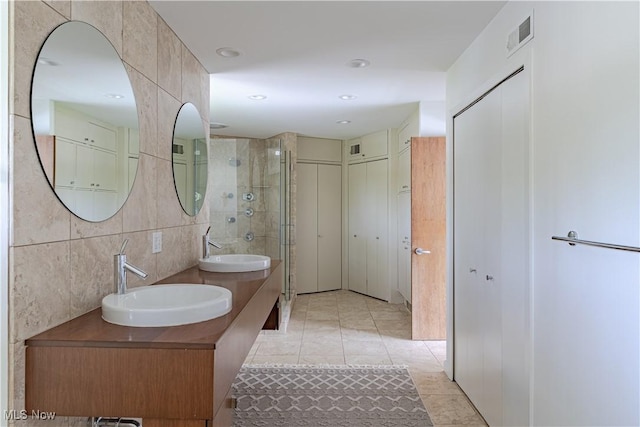 2471 Snowberry Ln, Pepper Pike, OH 44124 - full bathroom with double vanity, a stall shower, tile patterned floors, tile walls, and recessed lighting