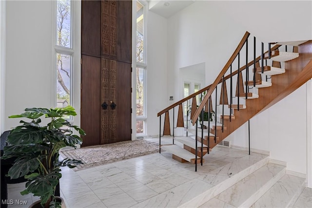 2471 Snowberry Ln, Pepper Pike, OH 44124 - foyer with a high ceiling, stairway, and marble look tile flooring