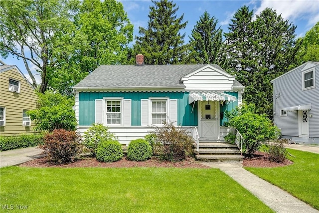 119 Adams Ave, Cuyahoga Falls, OH 44221 - bungalow-style home with a front yard, a chimney, board and batten siding, and roof with shingles