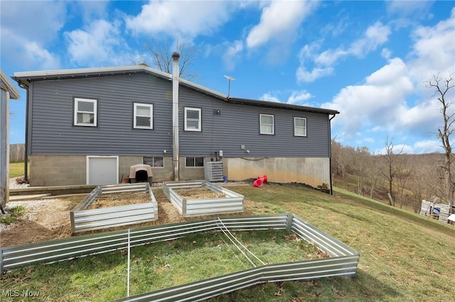 45725 Skyline Rd, Woodsfield, OH 43793 - back of property featuring a garden, a lawn, and central AC unit