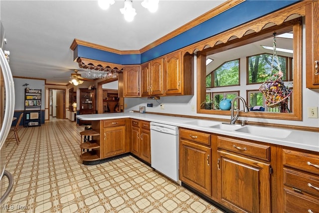 41972 Griswold Rd, Elyria, OH 44035 - kitchen with white dishwasher, a sink, brown cabinetry, open shelves, and ornamental molding