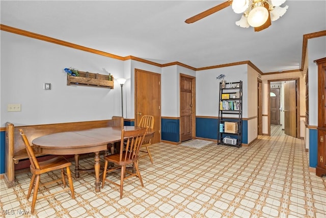 41972 Griswold Rd, Elyria, OH 44035 - dining area featuring a ceiling fan, wainscoting, and crown molding