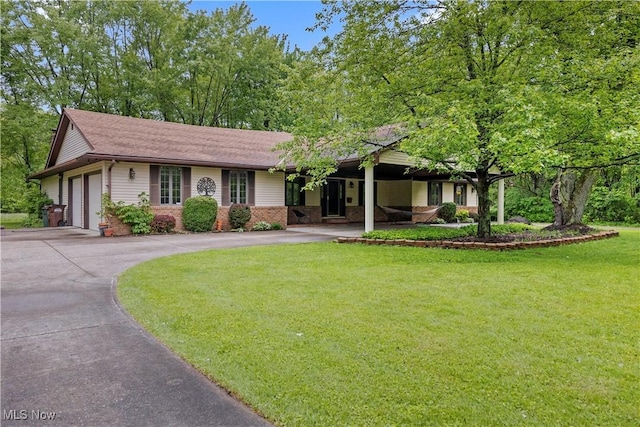 41972 Griswold Rd, Elyria, OH 44035 - ranch-style home with driveway, a front lawn, a garage, and a shingled roof