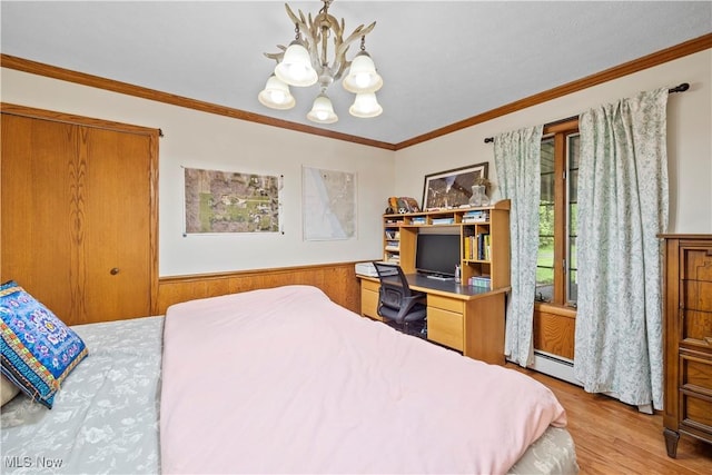 41972 Griswold Rd, Elyria, OH 44035 - bedroom featuring a chandelier, wood finished floors, ornamental molding, a baseboard radiator, and a wainscoted wall