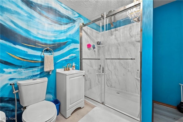 41972 Griswold Rd, Elyria, OH 44035 - bathroom with toilet, a marble finish shower, a textured ceiling, a chandelier, and vanity