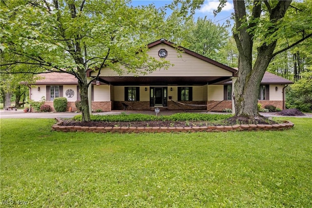 41972 Griswold Rd, Elyria, OH 44035 - view of front of home featuring brick siding, a front lawn, and a porch