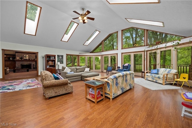 41972 Griswold Rd, Elyria, OH 44035 - living area featuring a skylight, high vaulted ceiling, a ceiling fan, and wood finished floors