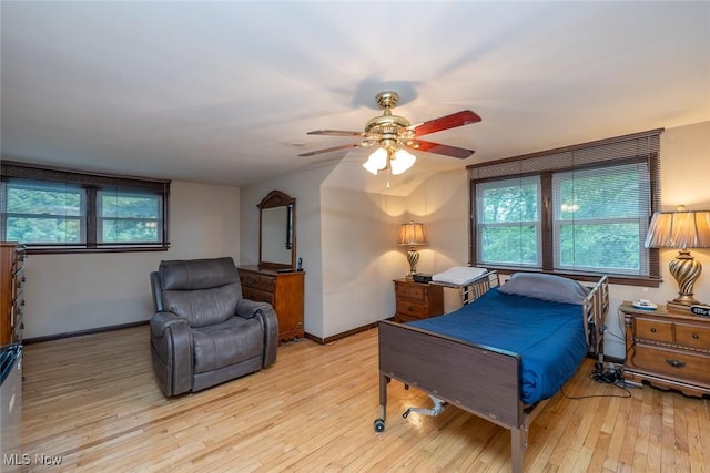 2639 Whiton Rd, University Heights, OH 44118 - bedroom with light wood finished floors, multiple windows, baseboards, and ceiling fan