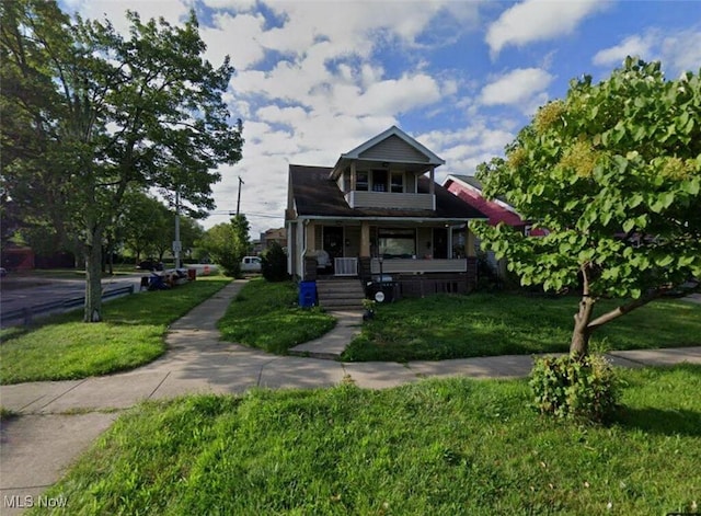 bungalow-style home with a porch and a front lawn