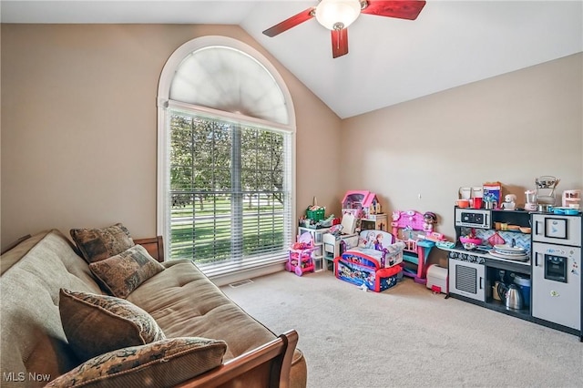 recreation room with carpet, vaulted ceiling, and a ceiling fan