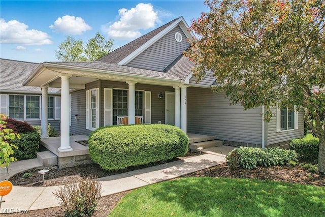 view of front facade with covered porch and a shingled roof