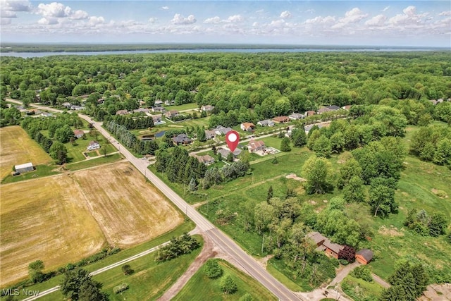 aerial view of property's location featuring a heavily wooded area and a large body of water