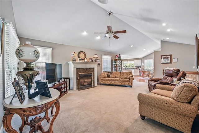 living area with vaulted ceiling, a ceiling fan, carpet flooring, a high end fireplace, and recessed lighting