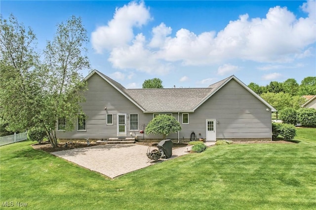 rear view of property with a patio area and a shingled roof