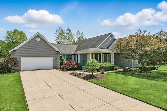 view of front of house featuring a garage, driveway, and a front lawn