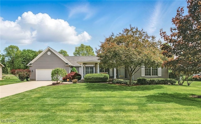 view of front of property featuring a garage, driveway, and a front yard