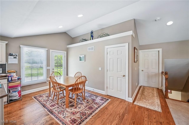 dining room featuring vaulted ceiling, light wood finished floors, baseboards, and recessed lighting