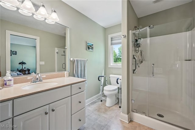 full bath with a stall shower, baseboards, vanity, toilet, and tile patterned flooring