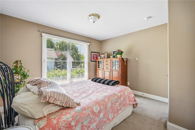 bedroom featuring baseboards and carpet