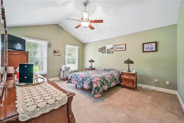 carpeted bedroom featuring vaulted ceiling, baseboards, and a ceiling fan