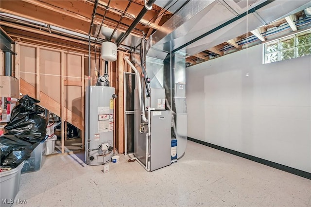 basement with water heater, tile patterned floors, heating unit, and baseboards