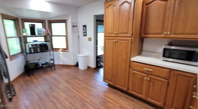 61426 Stillmeadow Ln, New Concord, OH 43762 - kitchen with stainless steel microwave, healthy amount of natural light, light countertops, and light wood-style flooring