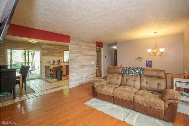4217 State Route 82, Mantua, OH 44255 - living area featuring a chandelier, light wood-type flooring, and a textured ceiling