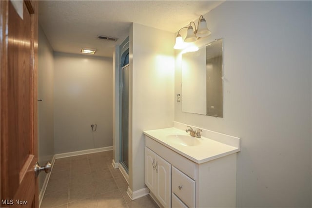 4217 State Route 82, Mantua, OH 44255 - full bath with tile patterned flooring, vanity, a textured ceiling, a shower with door, and baseboards
