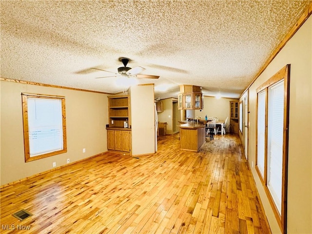 3000 Moxadarla Dr Unit 26, Zanesville, OH 43701 - unfurnished living room featuring light wood-type flooring, a ceiling fan, a textured ceiling, and ornamental molding