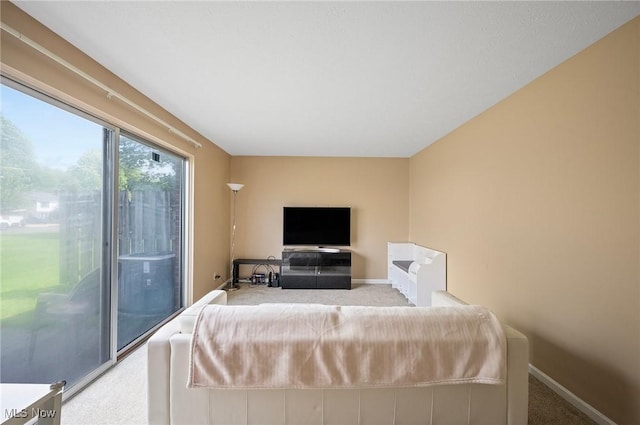 carpeted living room featuring baseboards