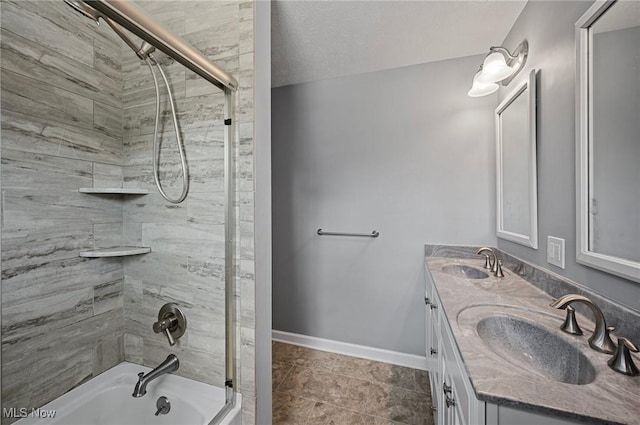 full bathroom with shower / washtub combination, double vanity, baseboards, and a textured ceiling