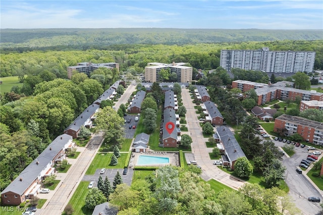 aerial view of a heavily wooded area and a pool area