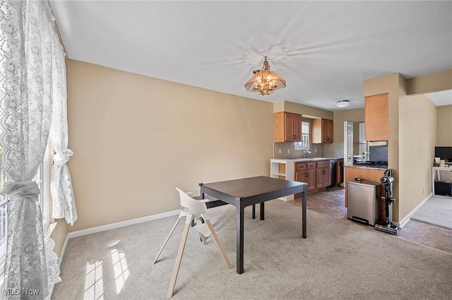 dining space featuring light carpet and baseboards