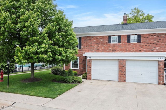 view of front facade featuring driveway, brick siding, a chimney, and a garage