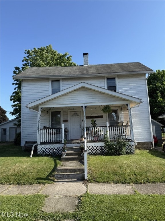 1521 Elm St, Coshocton, OH 43812 - view of front of home featuring covered porch, a chimney, and a front yard