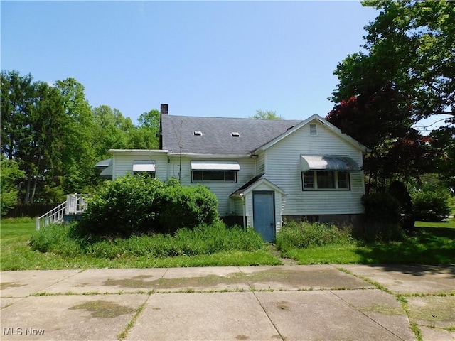 view of front of house featuring a chimney