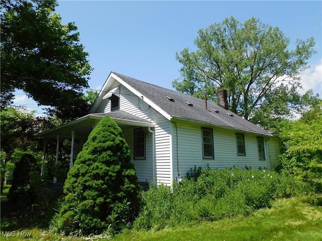 view of side of home featuring a chimney