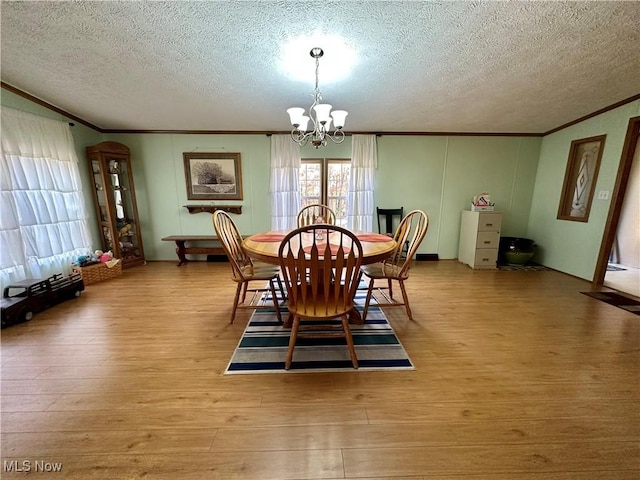9400 Chalon Rd, Scio, OH 43988 - dining area featuring crown molding, a chandelier, a textured ceiling, and wood finished floors