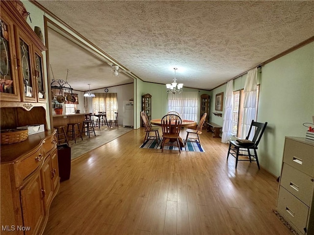 9400 Chalon Rd, Scio, OH 43988 - dining room featuring a chandelier, ornamental molding, wood finished floors, and a textured ceiling