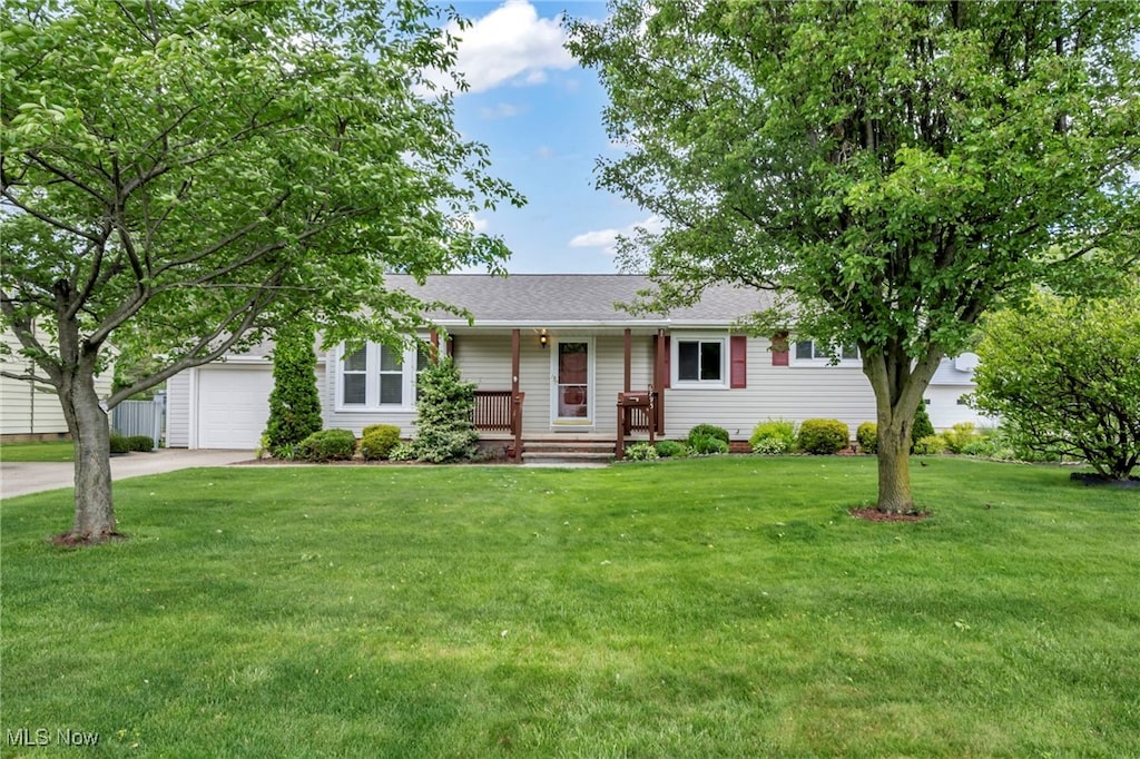 6795 Charles Rd, North Olmsted, OH 44070 - single story home with concrete driveway, a garage, a front lawn, a porch, and a shingled roof