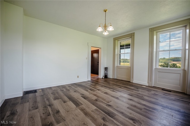 3153 SW Boltz Orchard Rd, Sugarcreek, OH 44681 - unfurnished dining area featuring a chandelier, dark wood finished floors, and baseboards