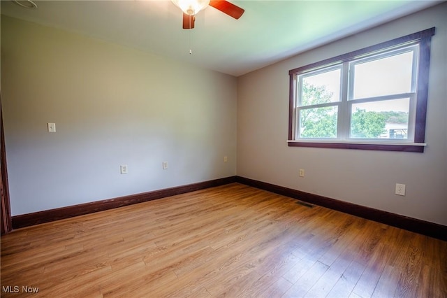 3153 SW Boltz Orchard Rd, Sugarcreek, OH 44681 - unfurnished room with a ceiling fan, light wood-style flooring, and baseboards