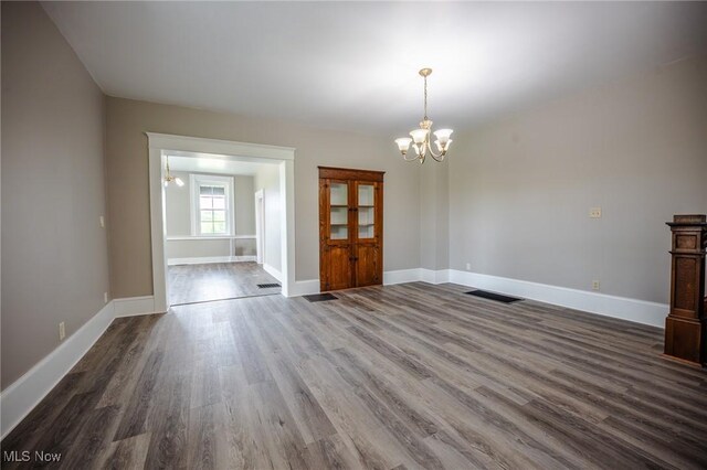 3153 SW Boltz Orchard Rd, Sugarcreek, OH 44681 - unfurnished dining area with a chandelier, dark wood-style floors, and baseboards