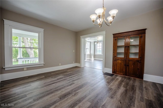 3153 SW Boltz Orchard Rd, Sugarcreek, OH 44681 - unfurnished dining area with a chandelier, dark wood-style floors, and baseboards