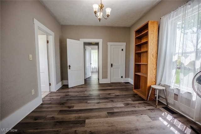 3153 SW Boltz Orchard Rd, Sugarcreek, OH 44681 - dining area featuring plenty of natural light, a chandelier, and dark wood-style flooring