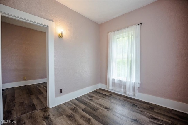 3153 SW Boltz Orchard Rd, Sugarcreek, OH 44681 - spare room with dark wood-style floors, a textured wall, and baseboards