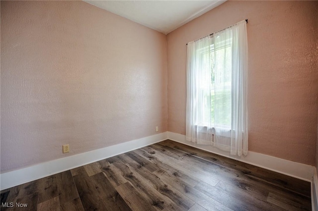 3153 SW Boltz Orchard Rd, Sugarcreek, OH 44681 - spare room with plenty of natural light, dark wood-style floors, and baseboards