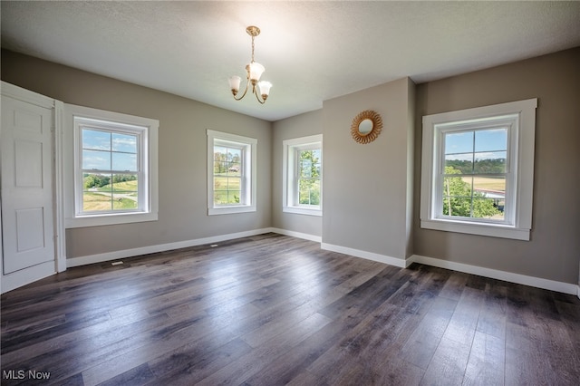 3153 SW Boltz Orchard Rd, Sugarcreek, OH 44681 - unfurnished room with a chandelier, healthy amount of natural light, and dark wood-style floors